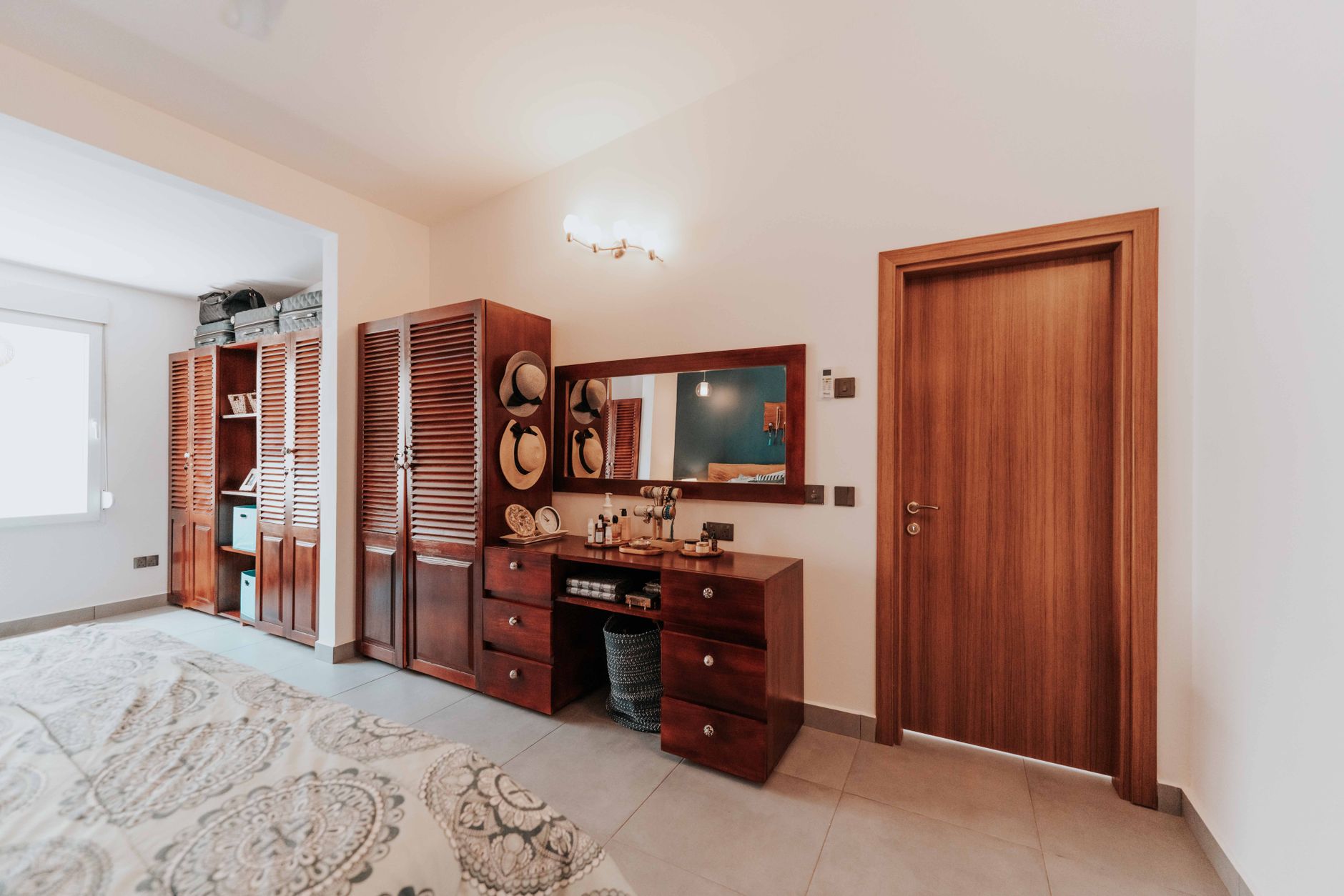 Warm and inviting bedroom interior featuring elegant wooden furniture and decor accents.