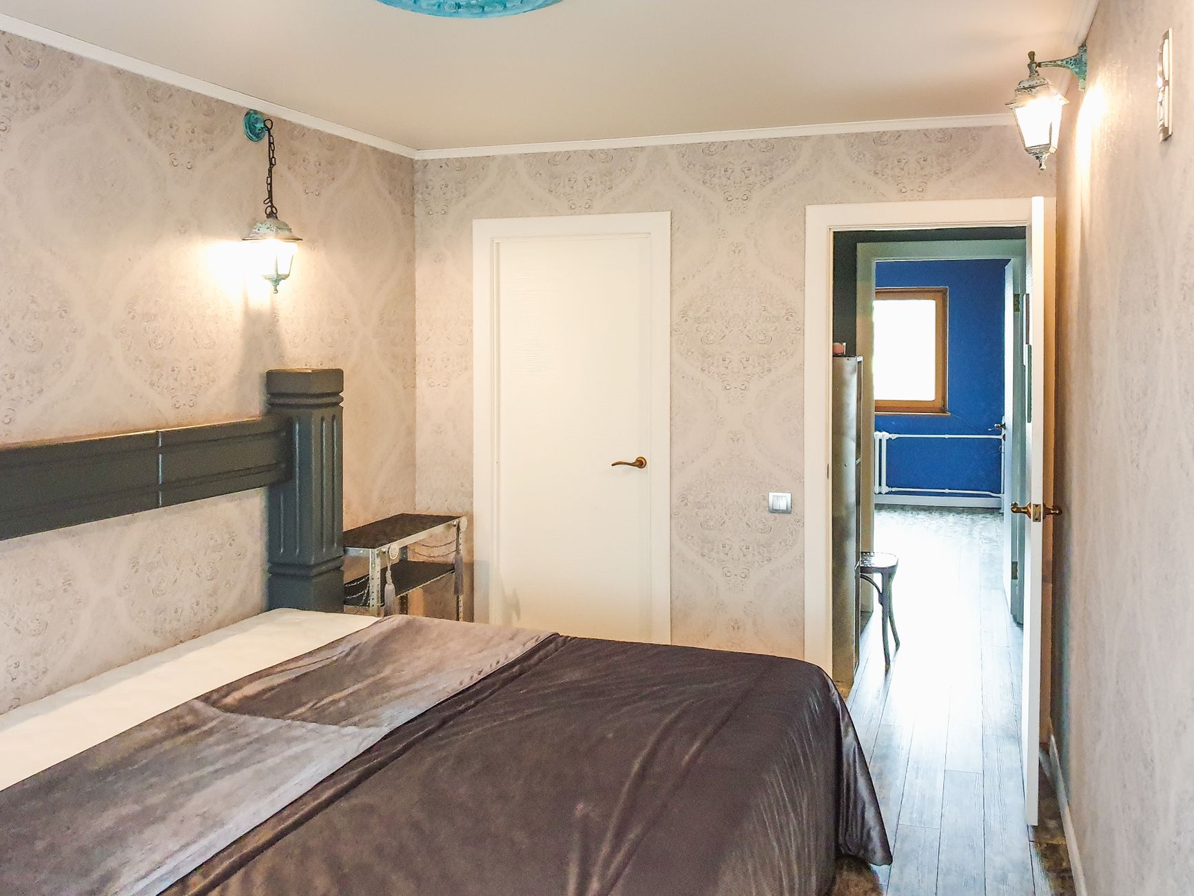 Warm and inviting bedroom with unique vintage decor, perfect for relaxation.