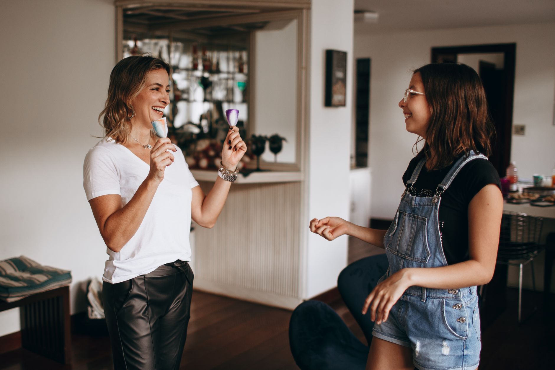 Smiling mother and daughter bonding indoors with fun and laughter.